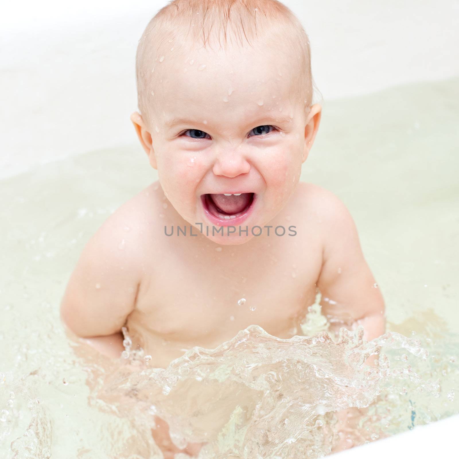 Cute little baby girl enjoying bathing