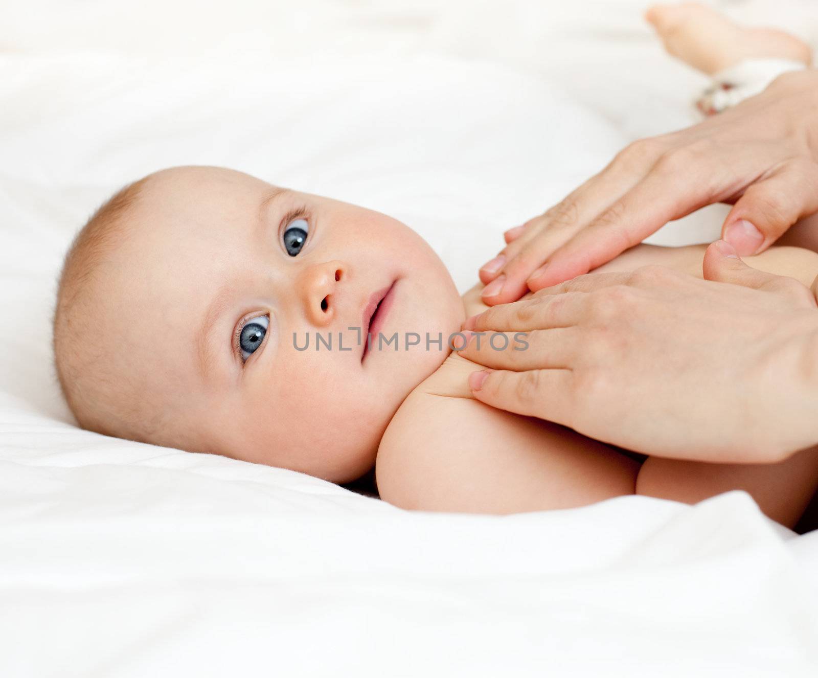 Mother massaging her child, shallow focus