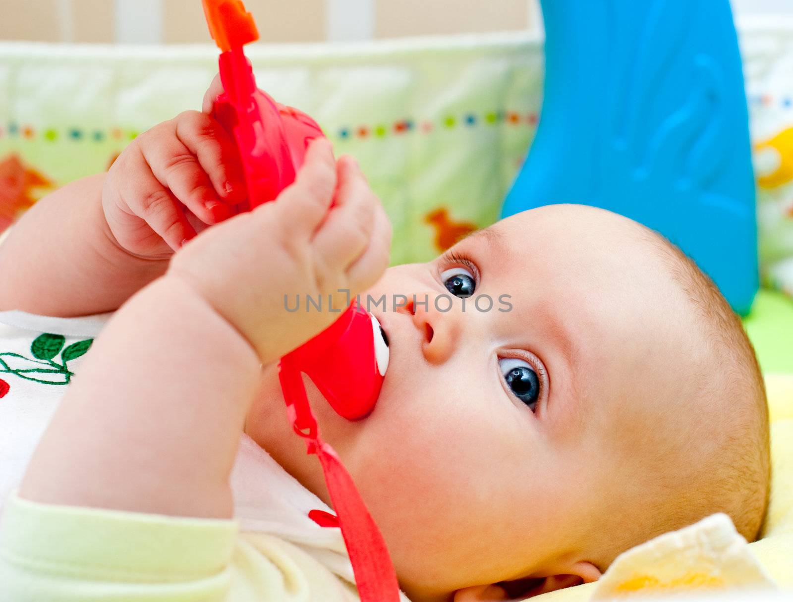 Infant with teething toy by naumoid
