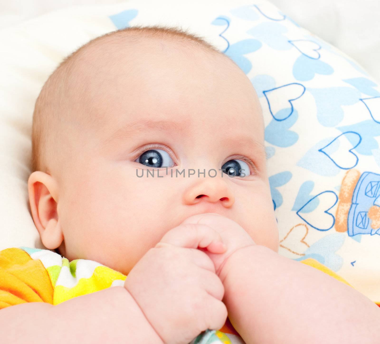Infant with hands in mouth by naumoid