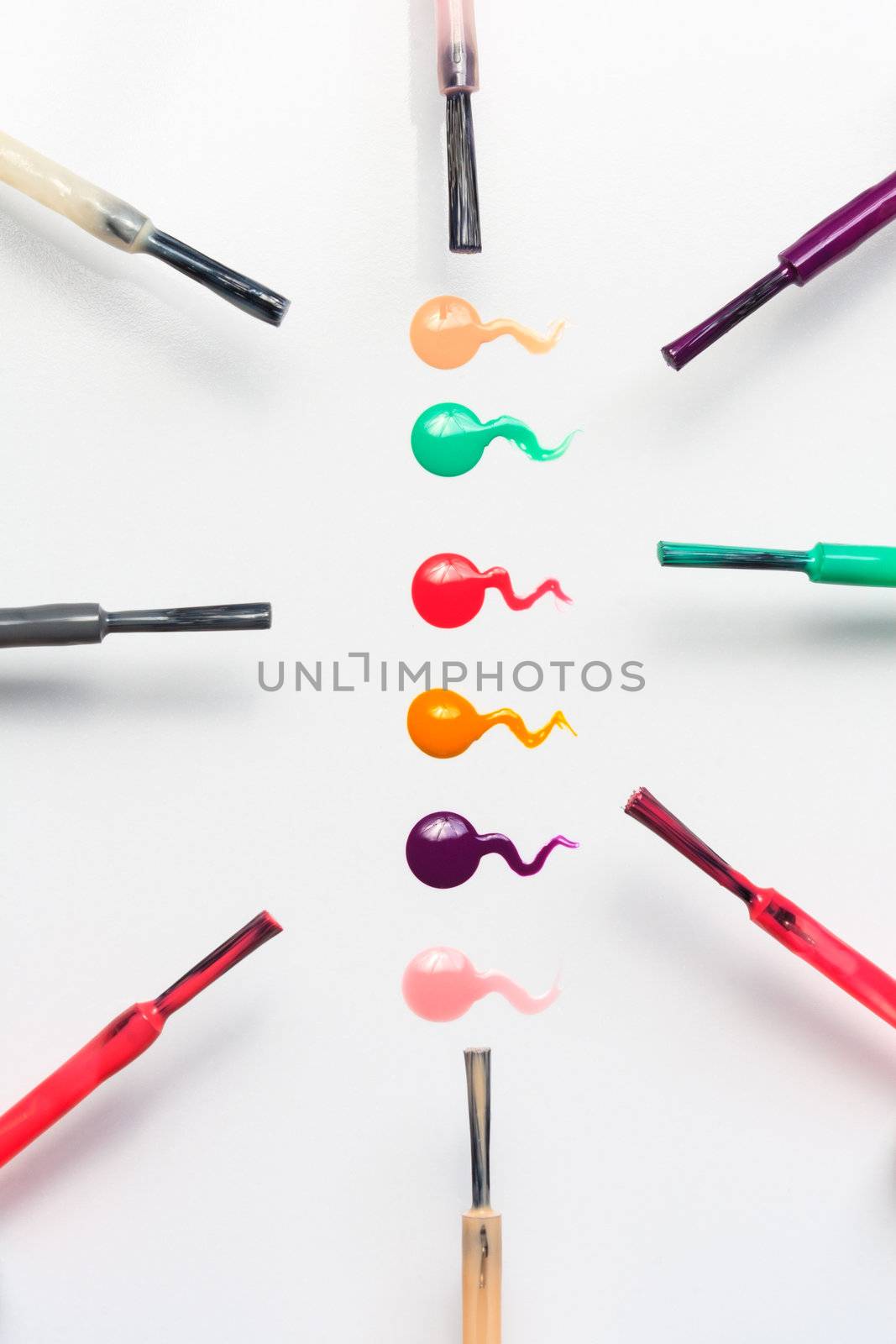 Set of multicolored nail polish brushes and drops by sfinks