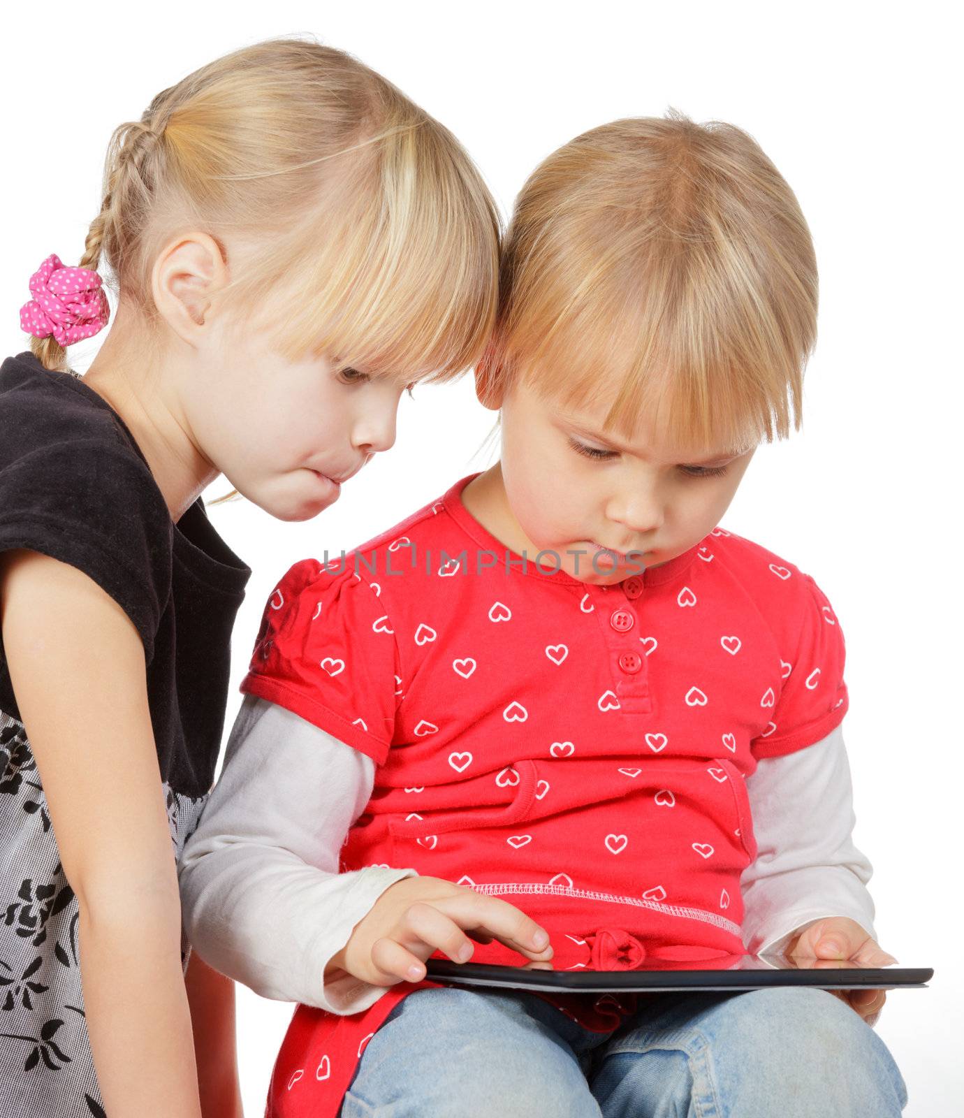 Two little girls using a touch pad