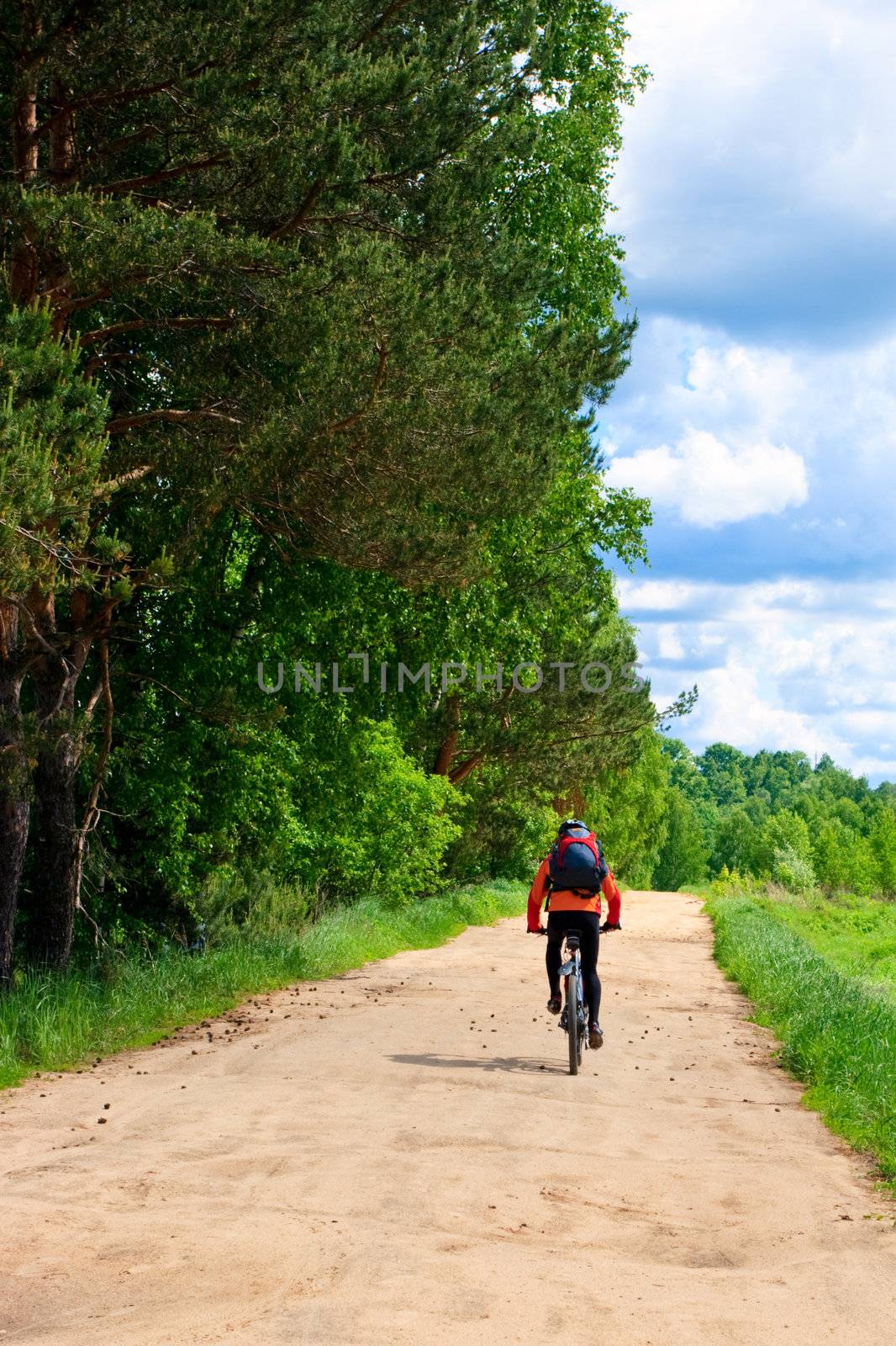 Traveling cyclists on dirt road
