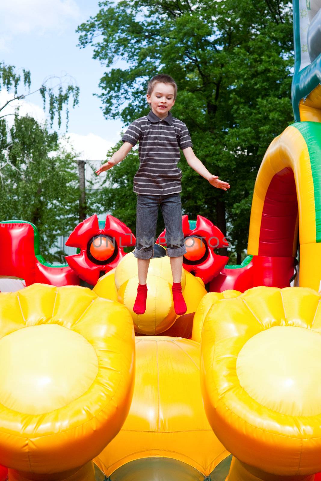 Young boy jumping on inflatable playground