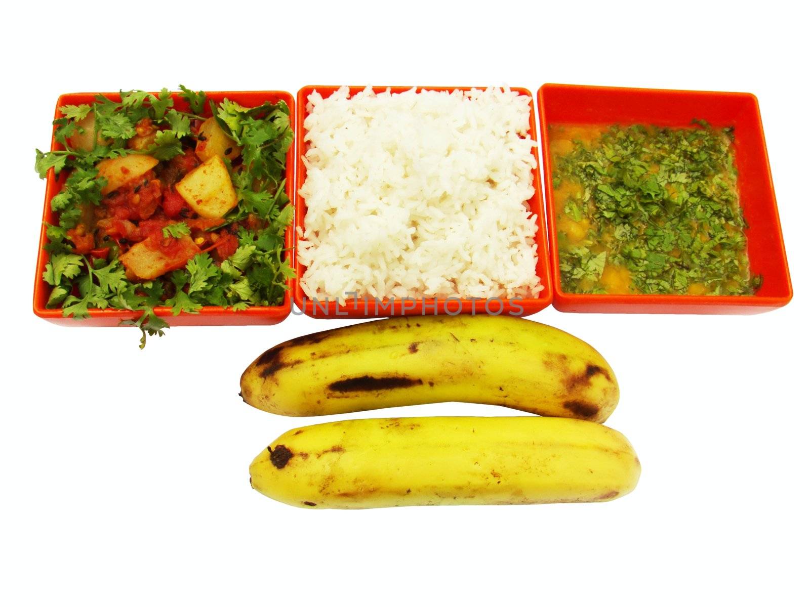 Vegetarian meal isolated on white. Meal contains steamed rice, cooked vegetables, cooked lentils and two ripen bananas