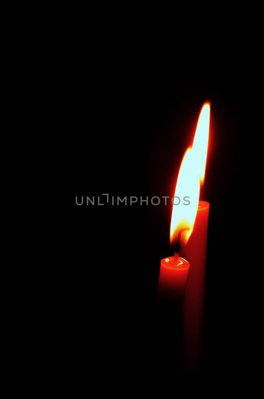 burning candle on black background by geargodz