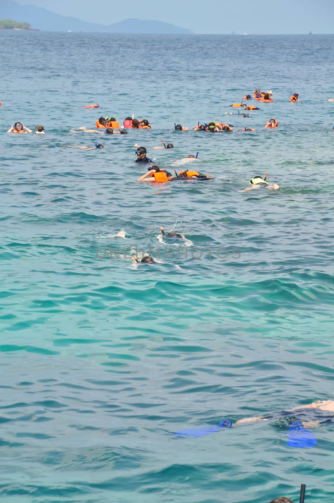 Active traveler diving snorkeling in beautiful clean ocean on summer vacation at Chang island, Thailand