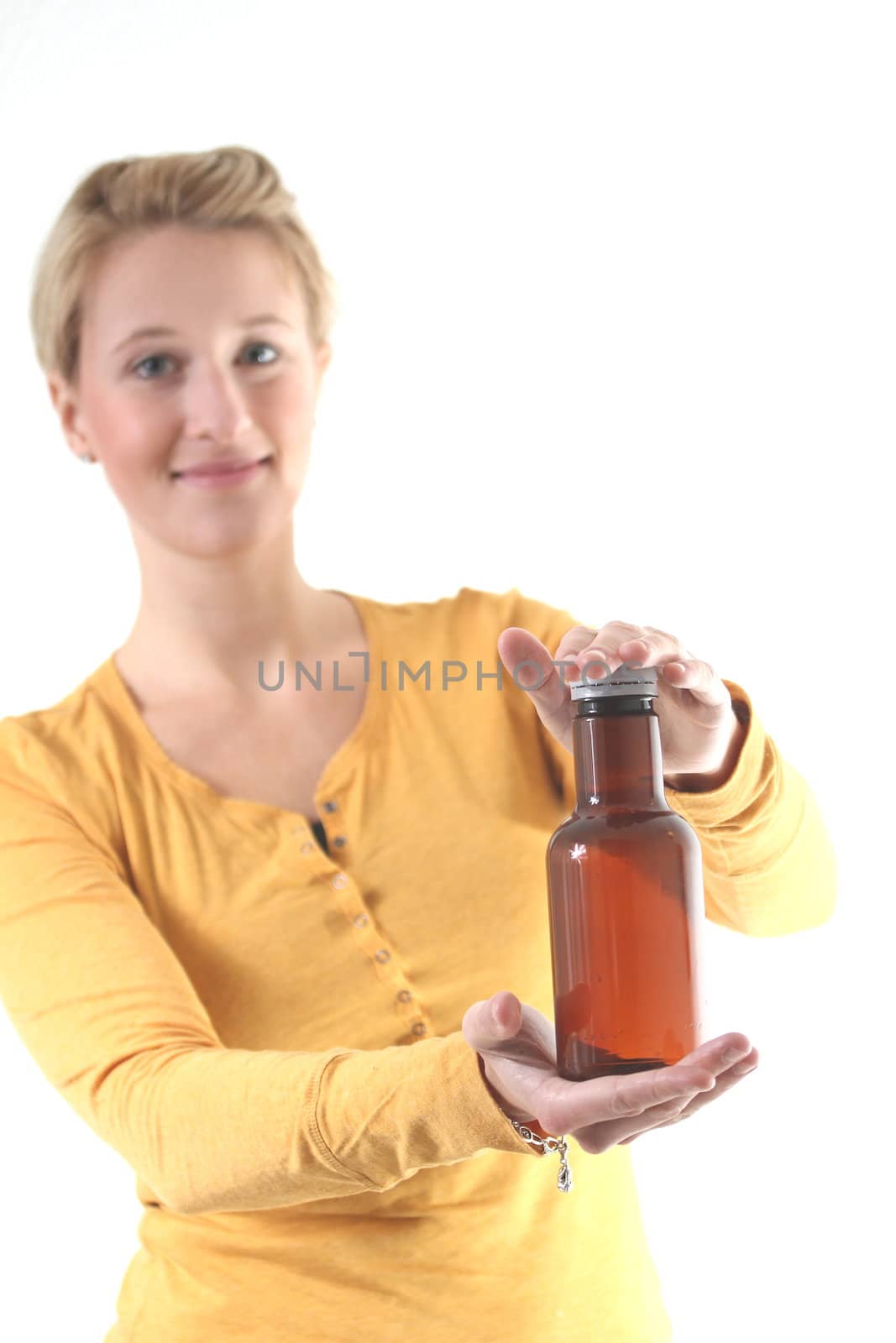 girl holding a brown plain bottle