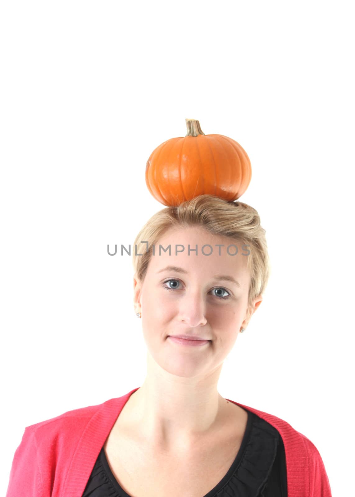 girl balancing a pumpkin on her head