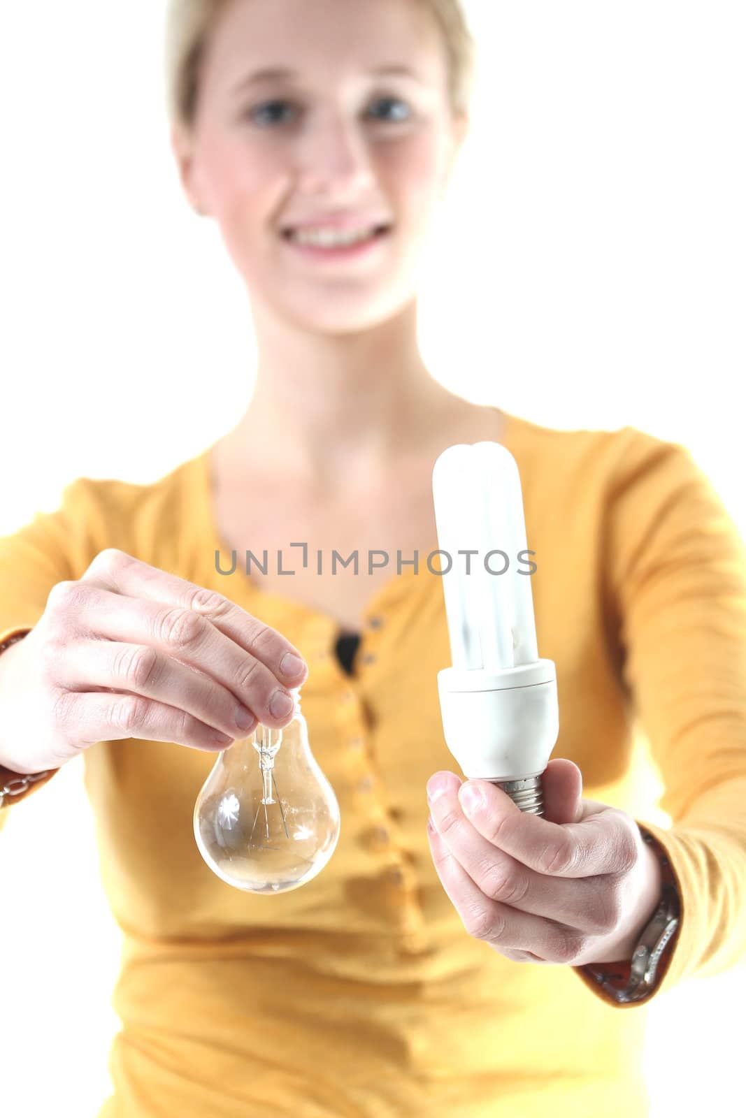 girl holding a energy-saving lamp and a light bulb