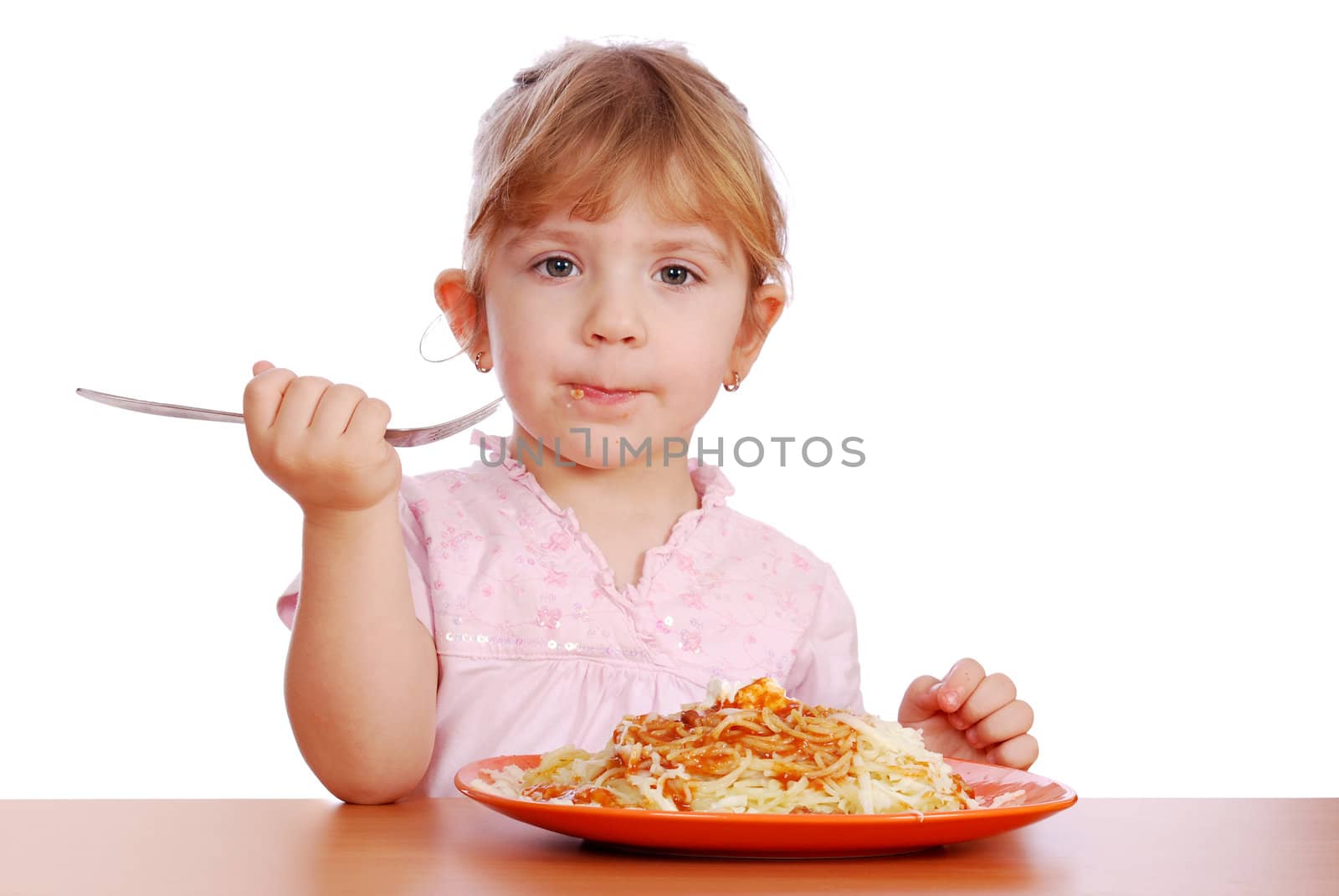 Little girl eating spaghetti studio shot