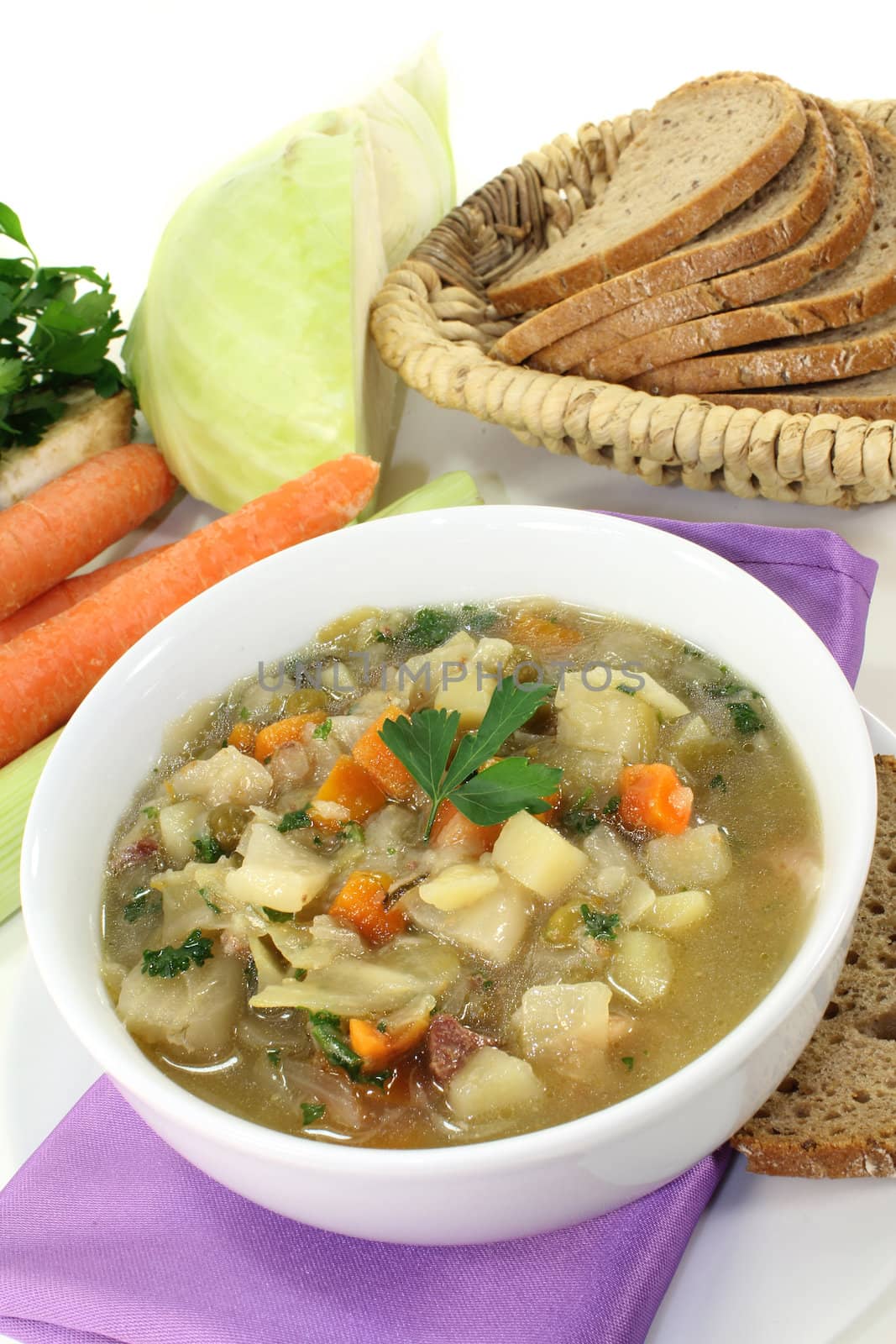 a bowl of cabbage soup and fresh parsley