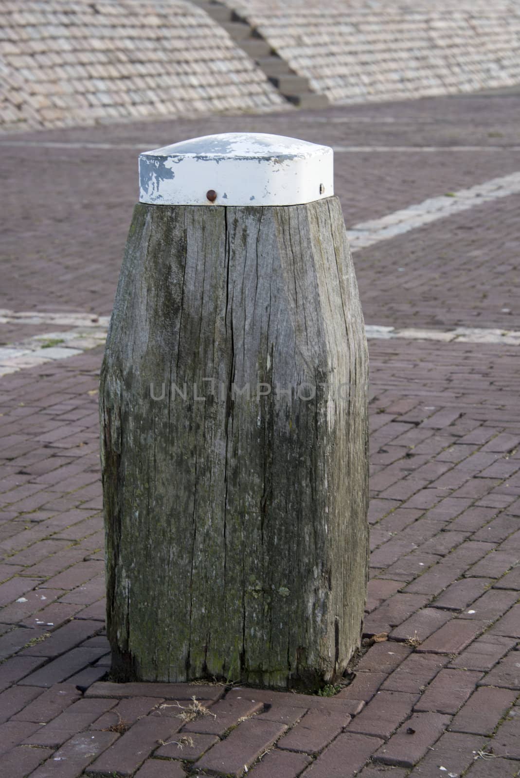 wooden bollard in the harbour to enter boat with ropes