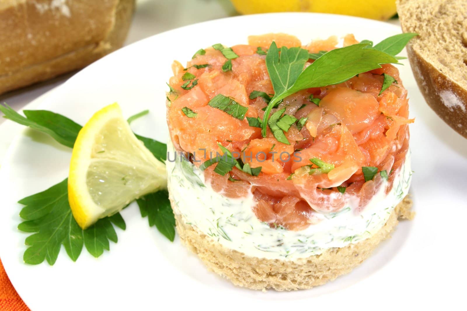 a slice of bread with herb cream and salmon tartare