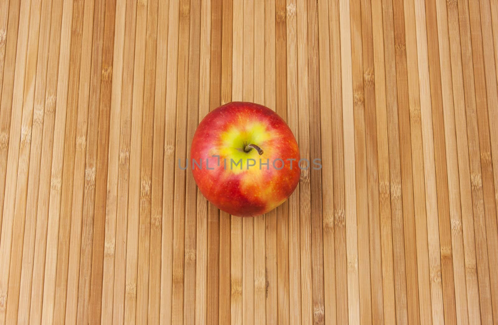 red apple lying on a bamboo napkin