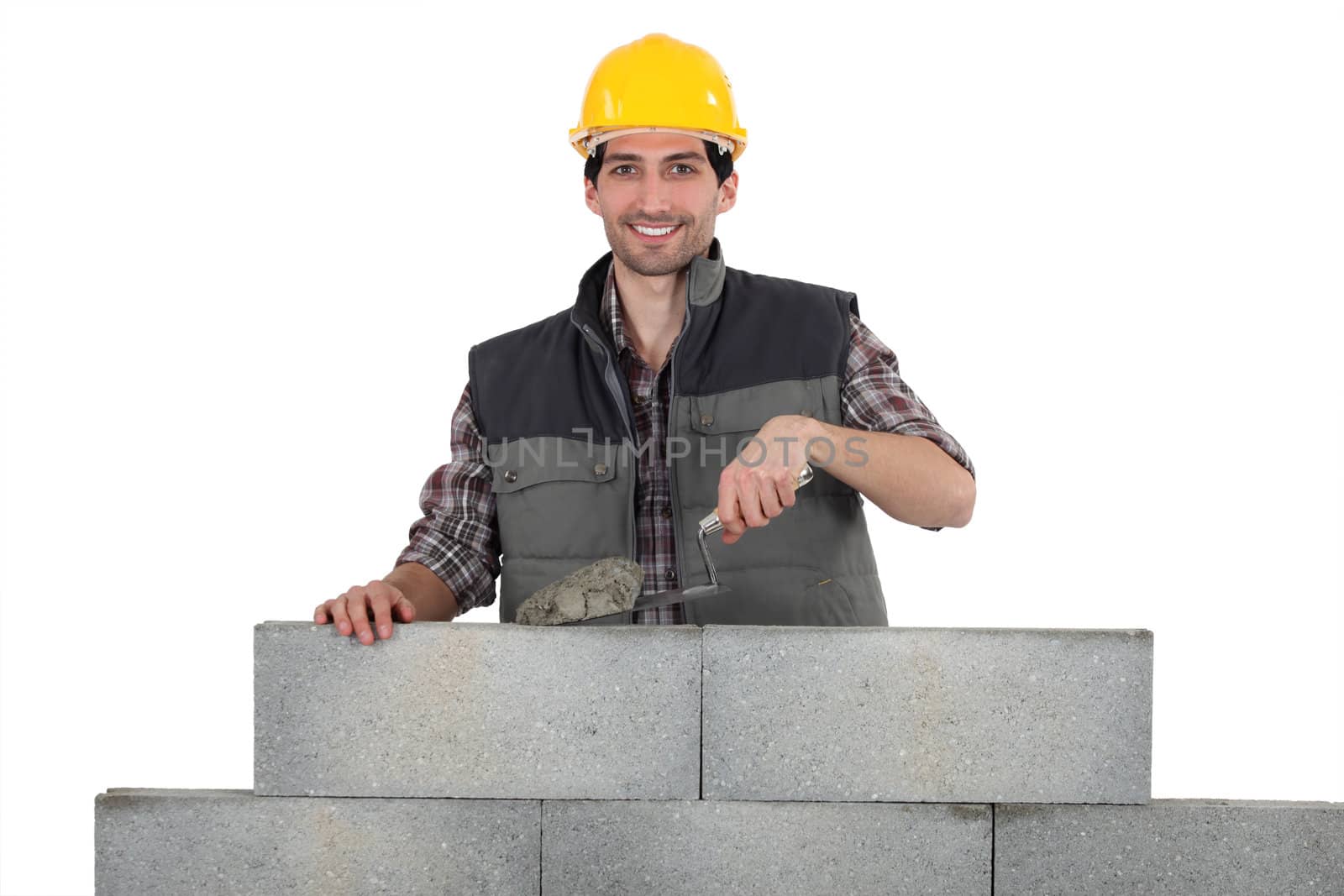 Bricklayer building a wall by phovoir