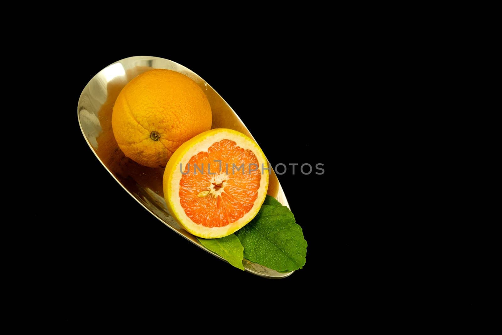 Oranges in a bowl with a black background