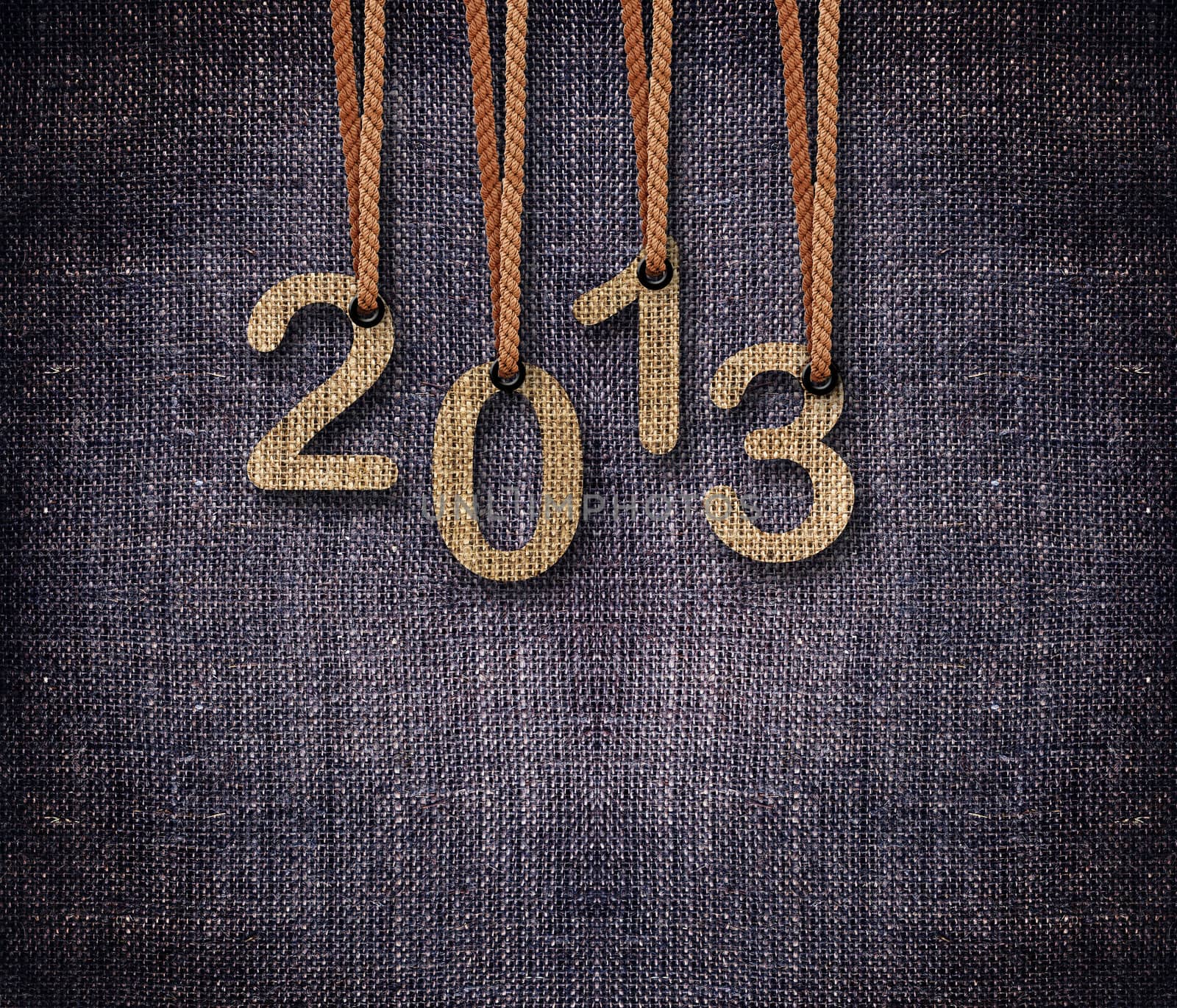 2013 numbers hunging by rope as puppeteer on sackcloth background.