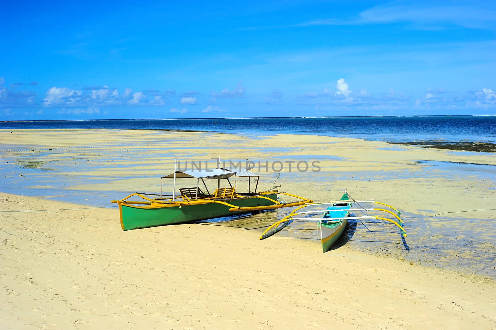 Traditional Philippines boats on the beach during the low tide on Shiargao island, Philippines