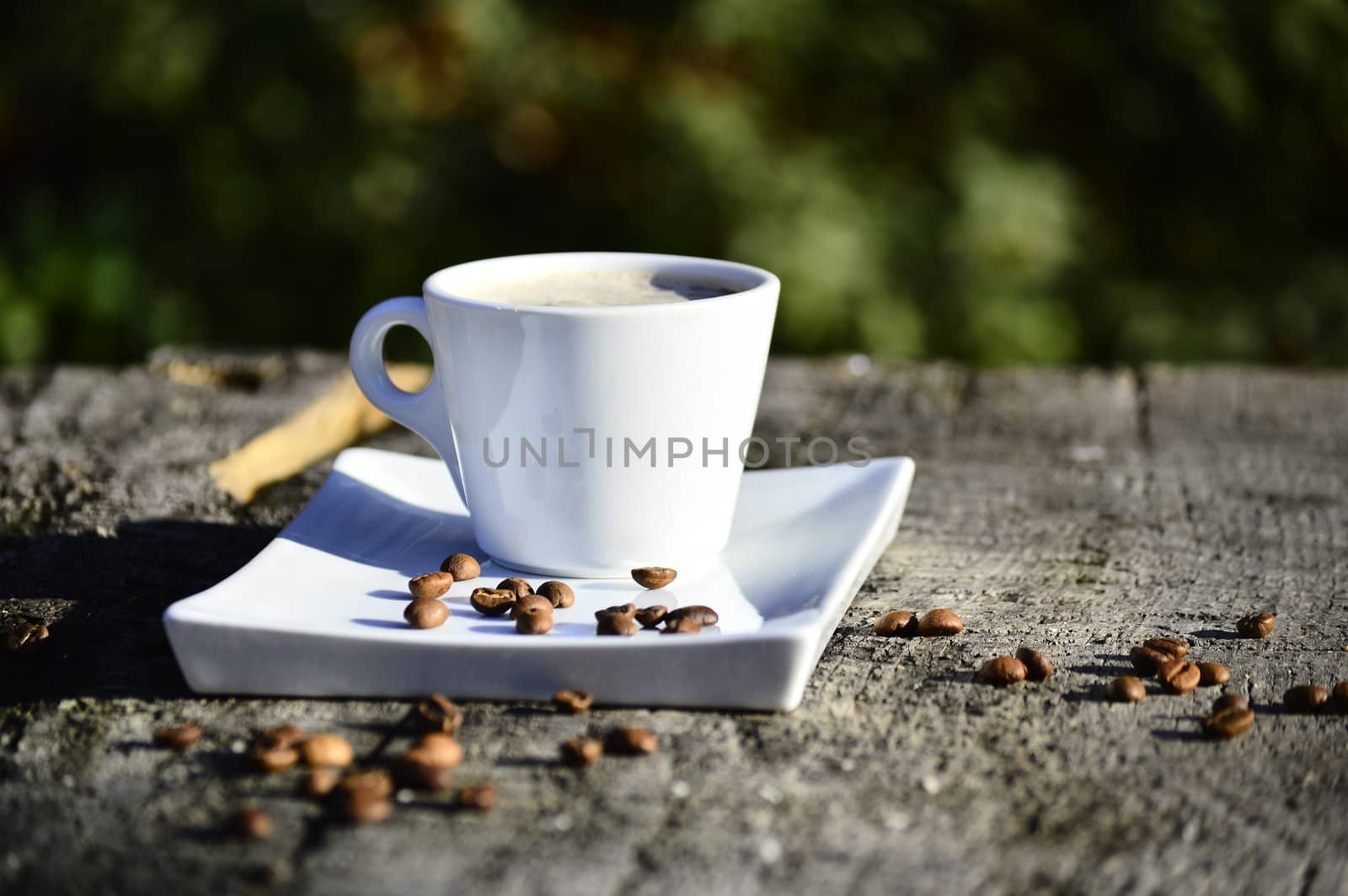 cup of coffee on a wooden table in daylight