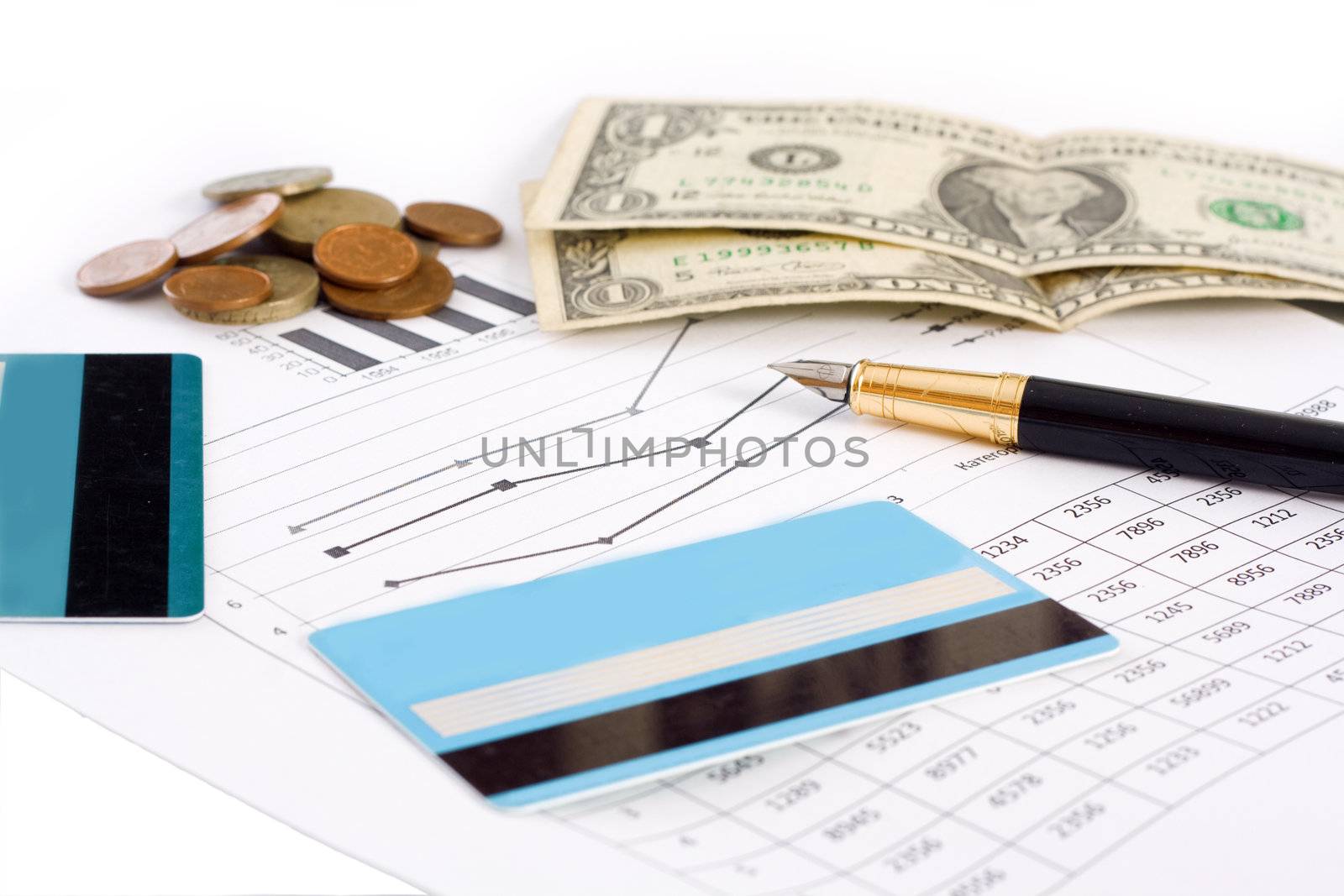 Planning for business. Credit cards, money, and graphics with pen isolated on white background