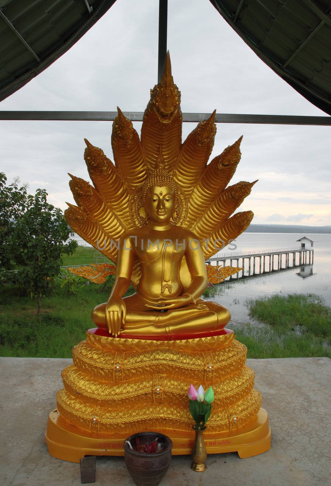 Golden buddha inside river dam of Thailand