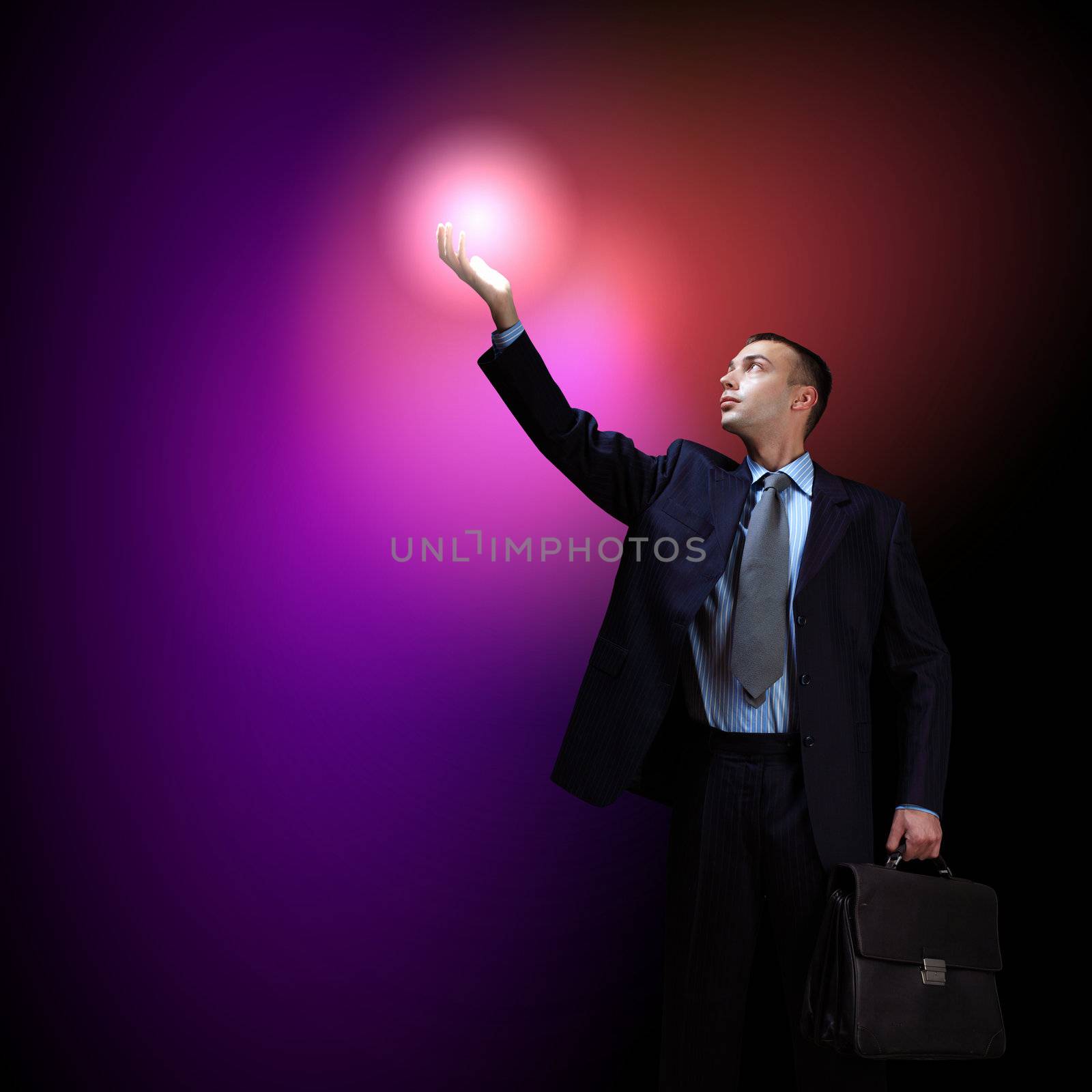 Businessman with light shining by sergey_nivens