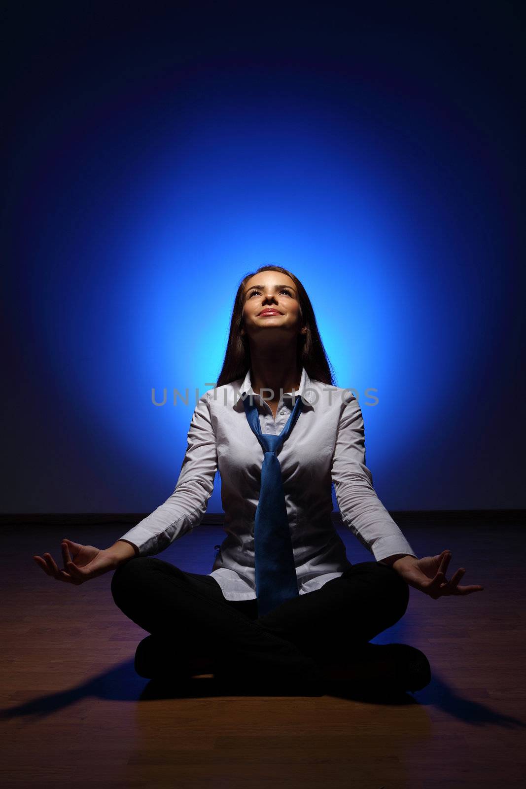 Young business woman sitting in asana lotus and meditating