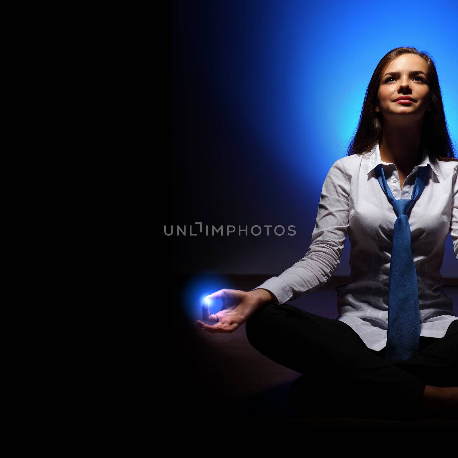 Young business woman sitting in asana lotus and meditating