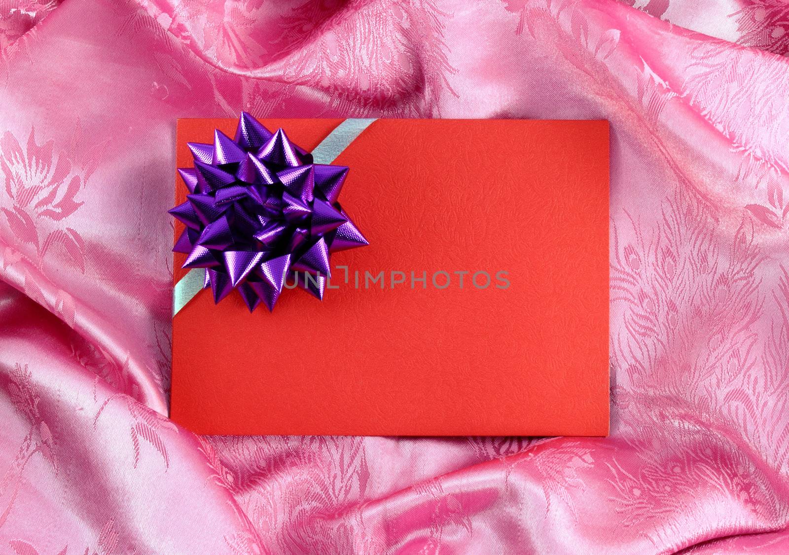 red blank gift card on pink satin by geargodz