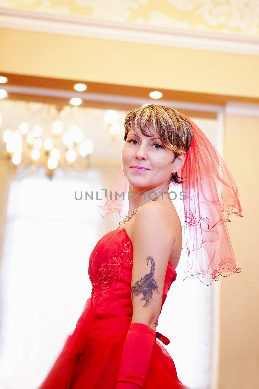 The beautiful bride in a red dress in the room