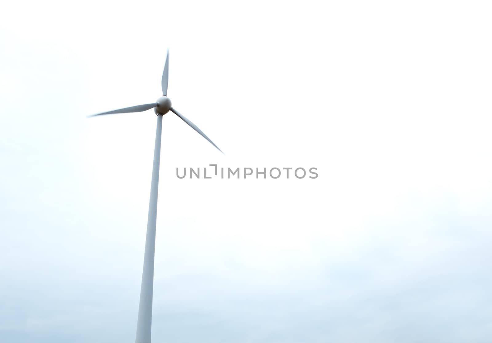 Wind turbine over the sky background.