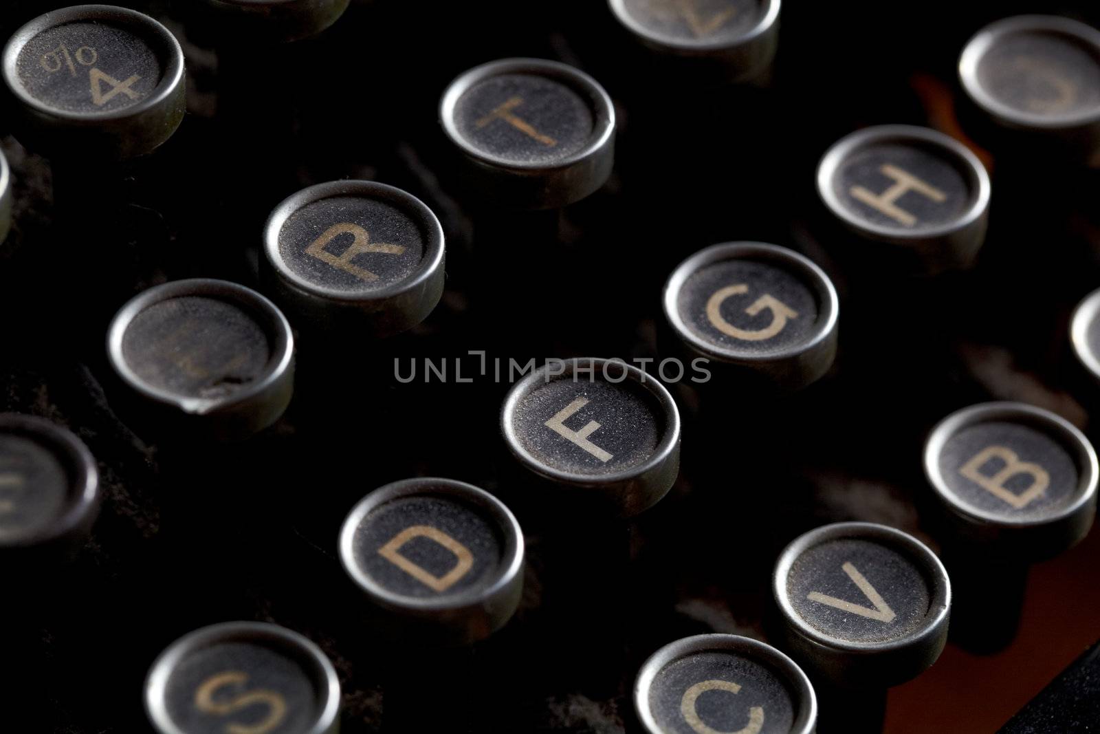 Close up photo of antique typewriter keys with dust, shallow focus