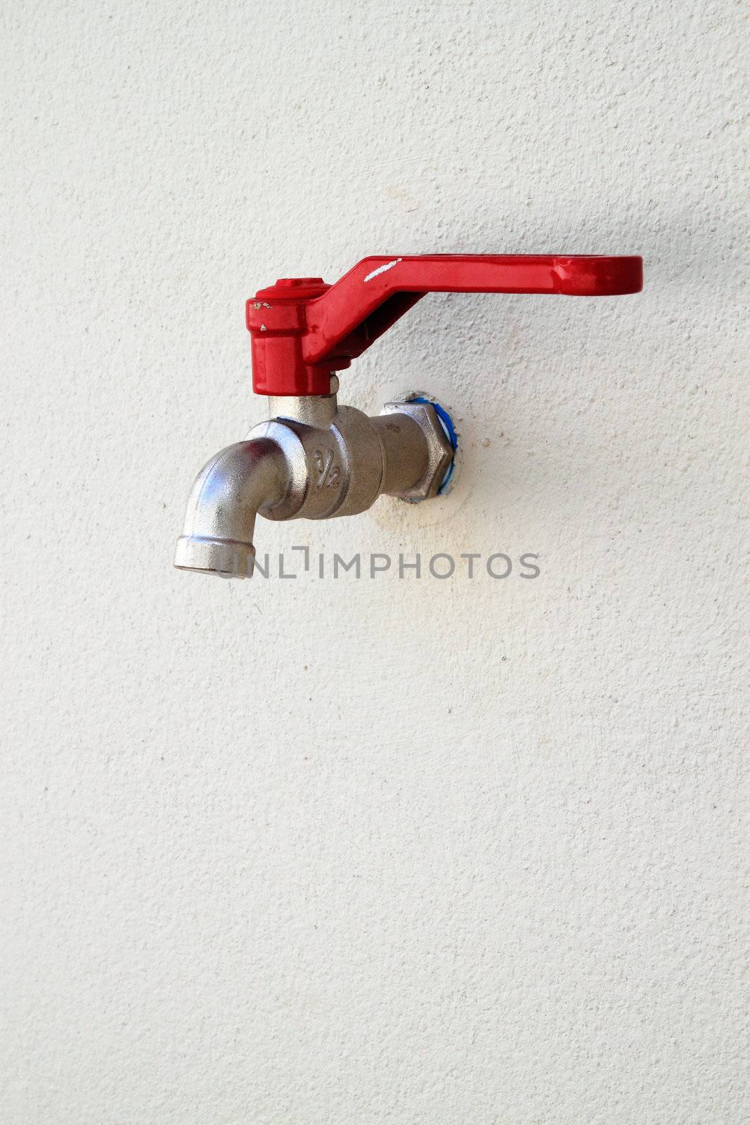 a faucet on white wall background in home