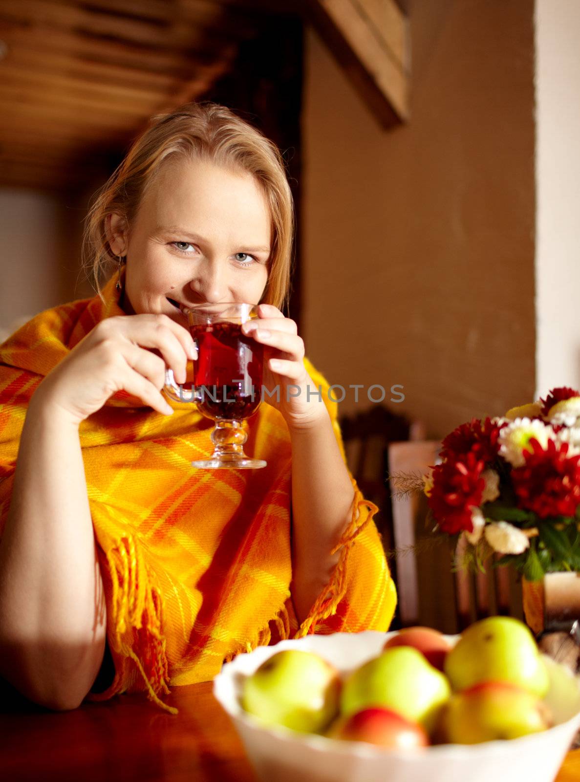 Young beautiful woman is having breakfast with apples and carcade tea.