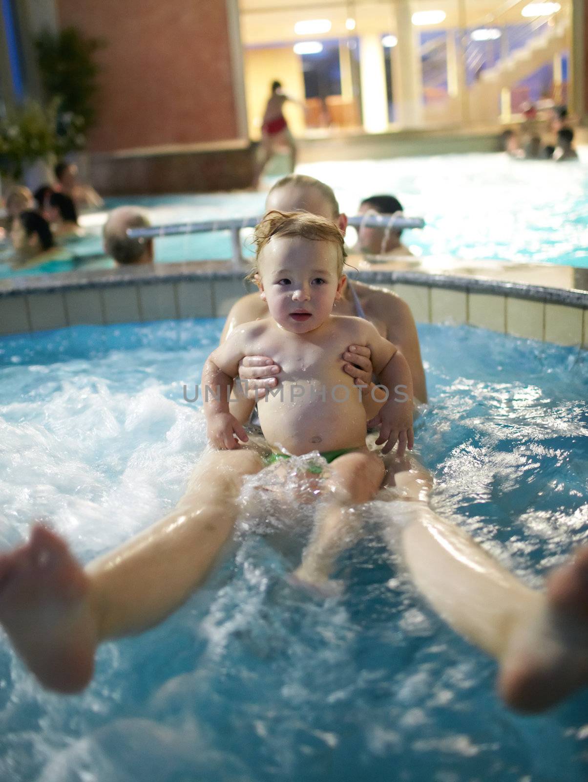 Mother with her kid in the spa bath