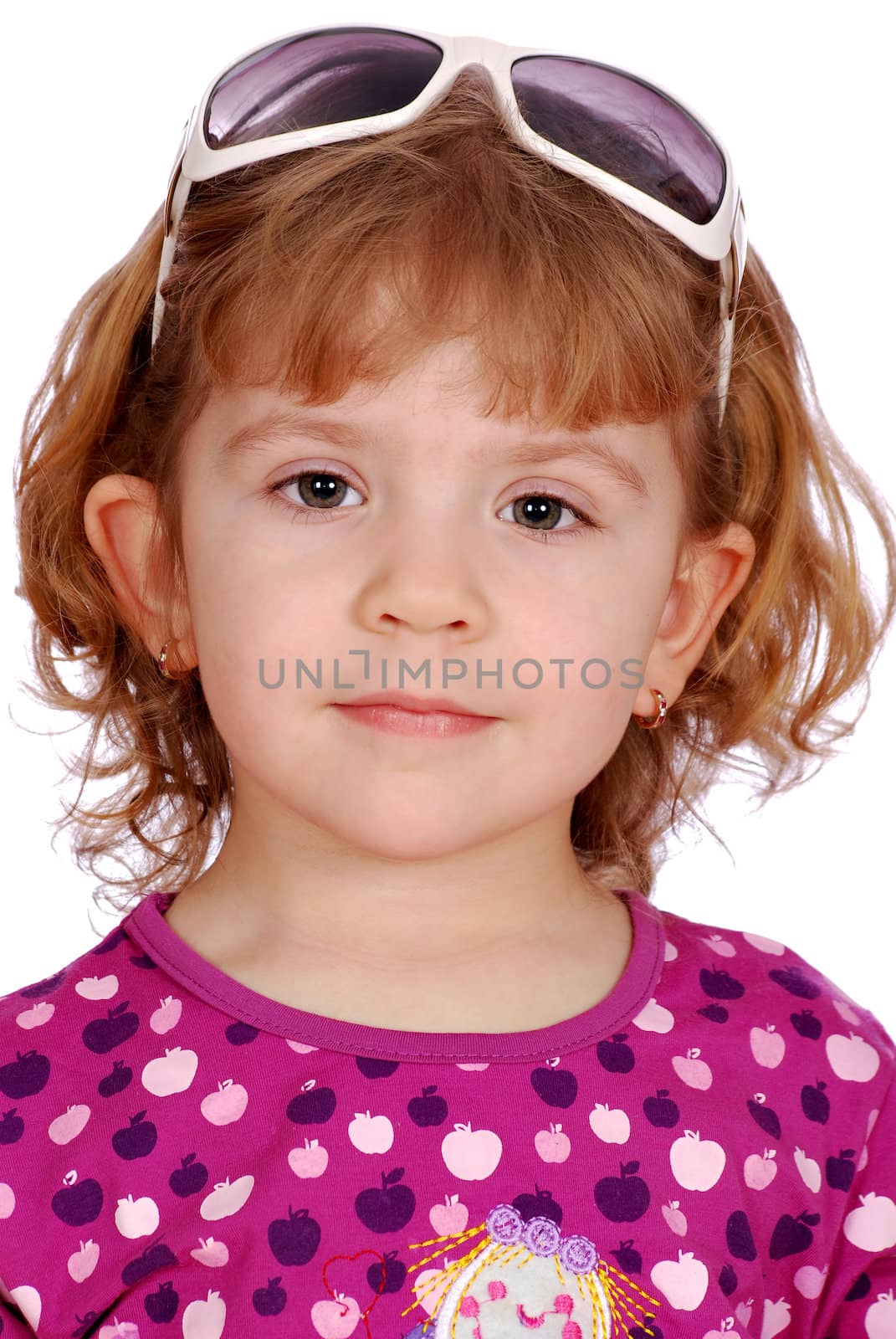 Little girl with sunglasses on head studio shot