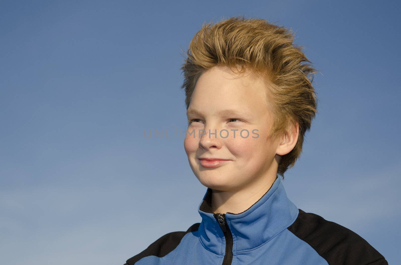 Portrait of guy with spiky hairstyle against blue sky
