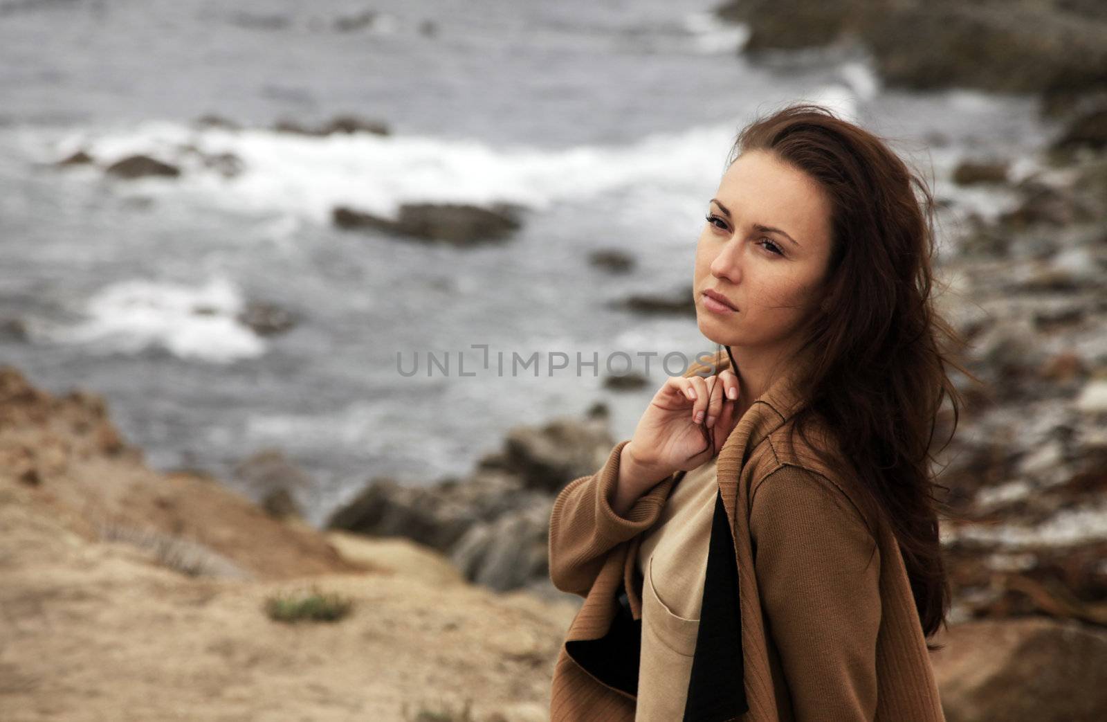 The beautiful thoughtful girl on a coast of ocean