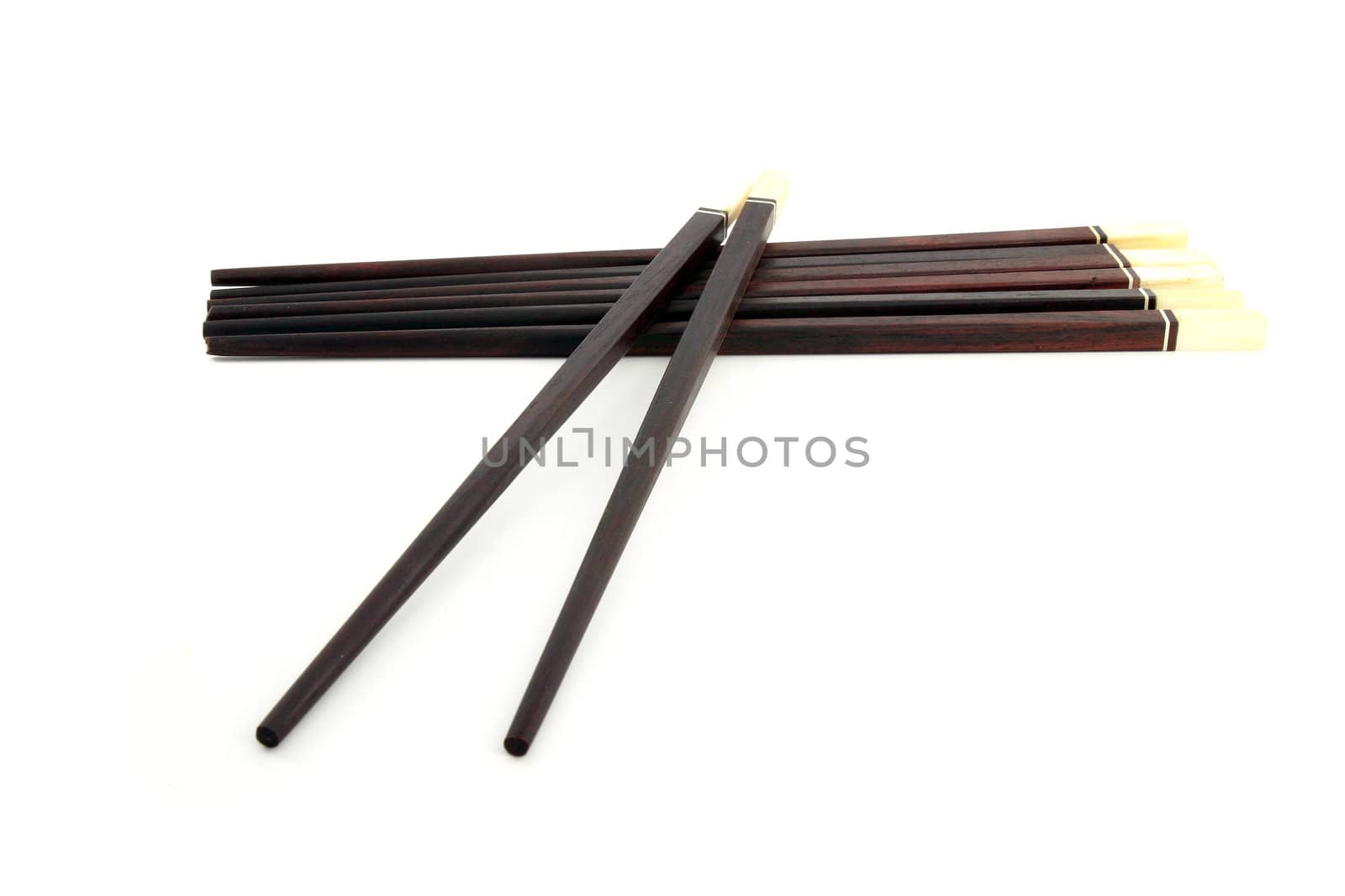 Thai wooden chopsticks on white background by geargodz