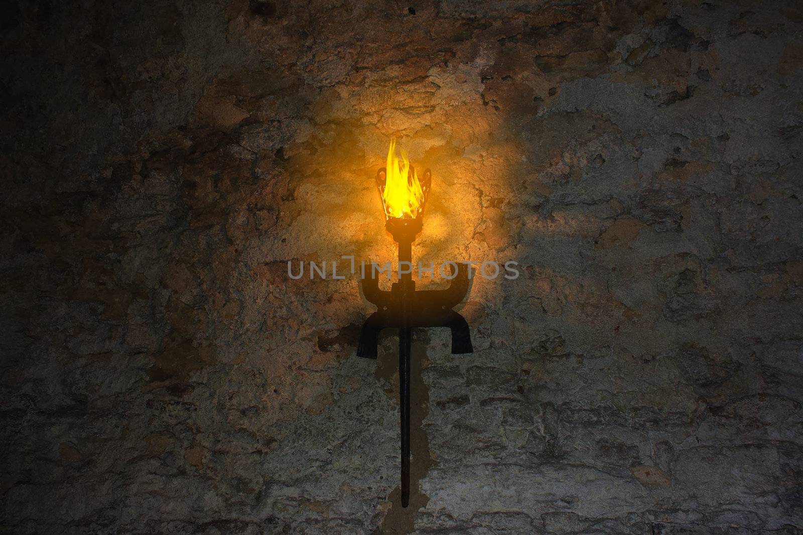 torch on the wall of an old castle by sfinks
