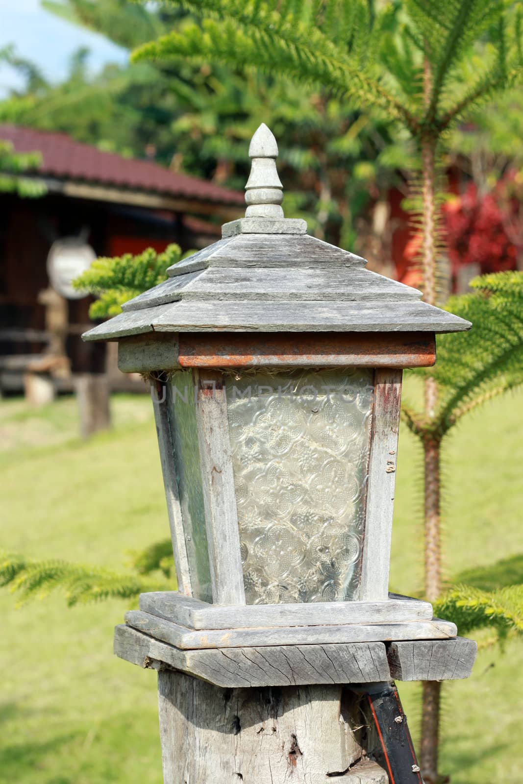 wood ancient lamp in garden of resort at Khaokho, Thailand  by geargodz
