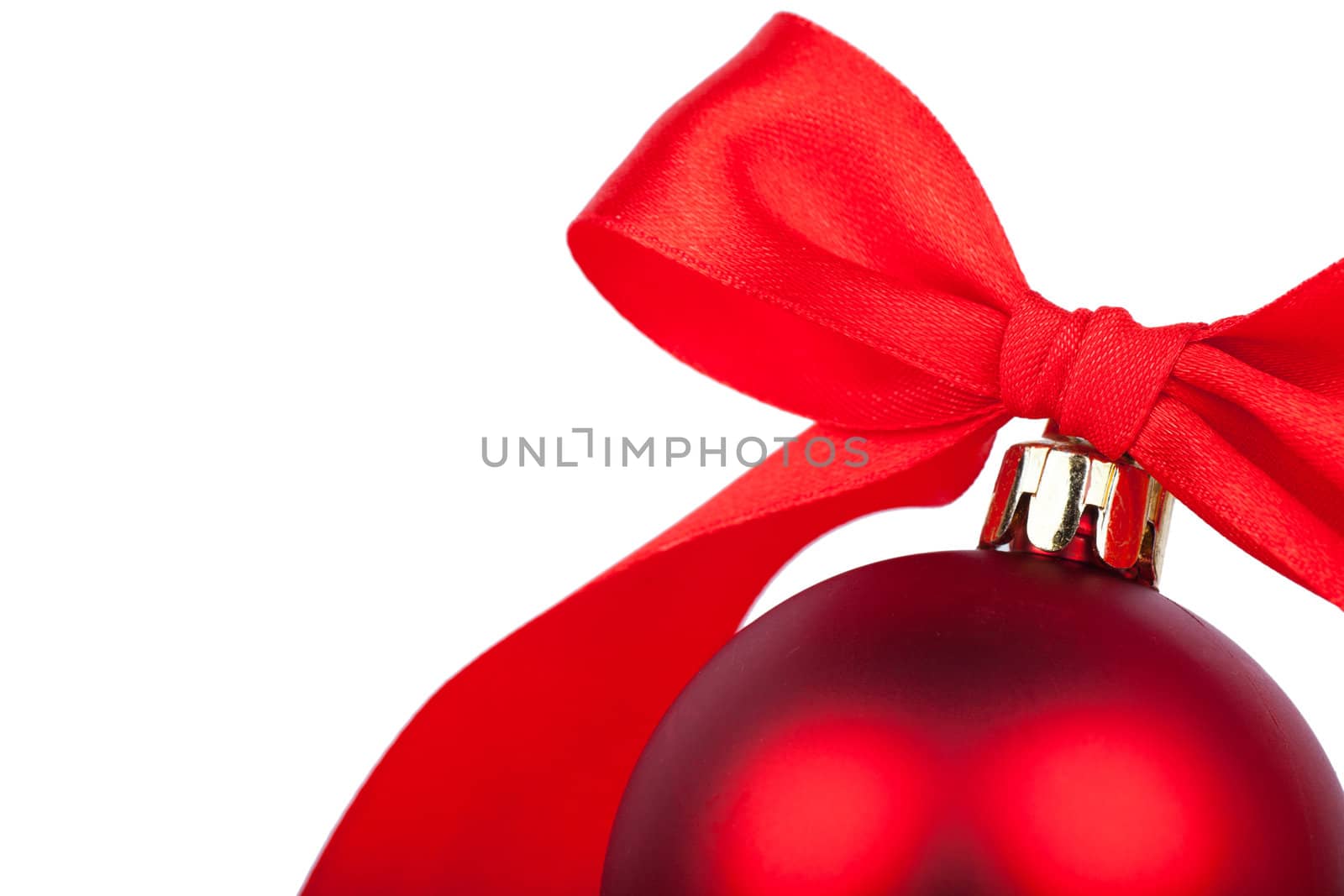 Red christmas ball with red bow over white background