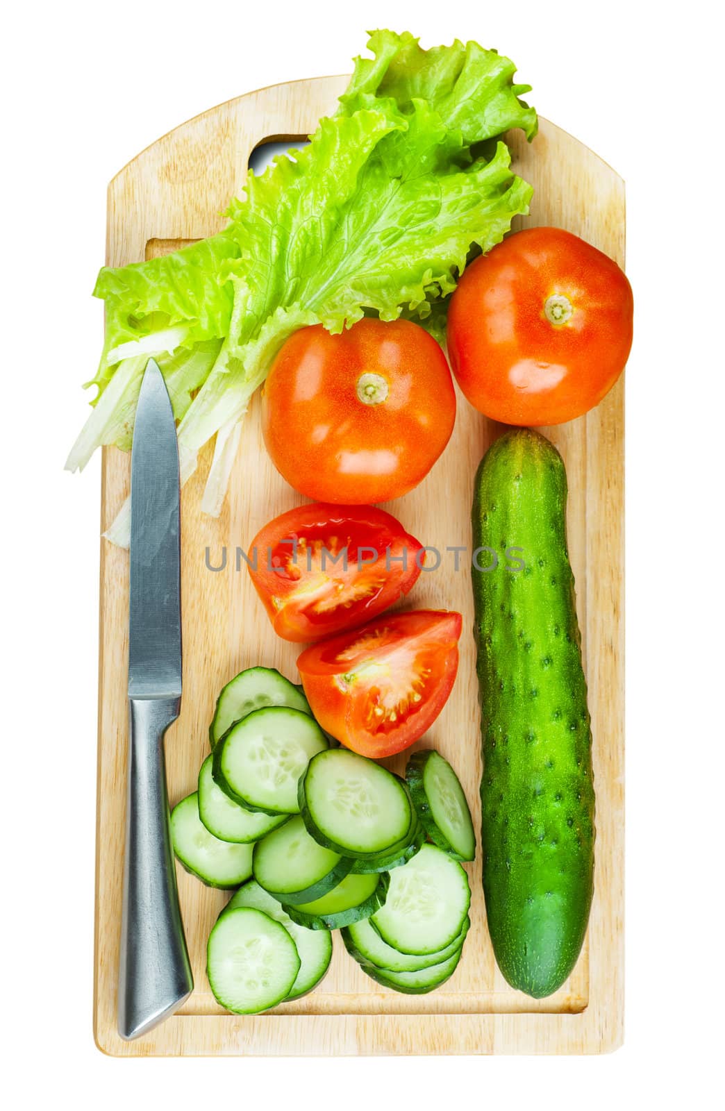 Cutting board with knife and vegetables isolated over white background