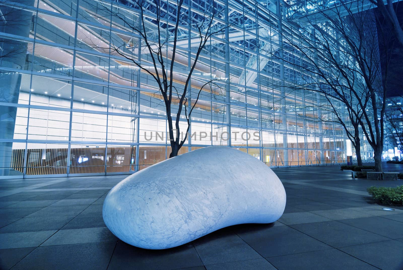 TOKYO, JAPAN -January 23, 2008 : white marble stone sculpture ISHINKI by Kan Yasuda inside futuristic environment of Tokyo International Forum by night