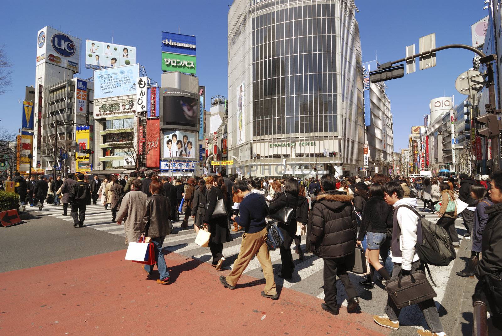 Tokyo, Japan - March 6,  2008 : Pedestrian crowd cross the famous Shibuya street crossing in Tokyo. Shibuya crossing is worldwide famous as most crowded city area.