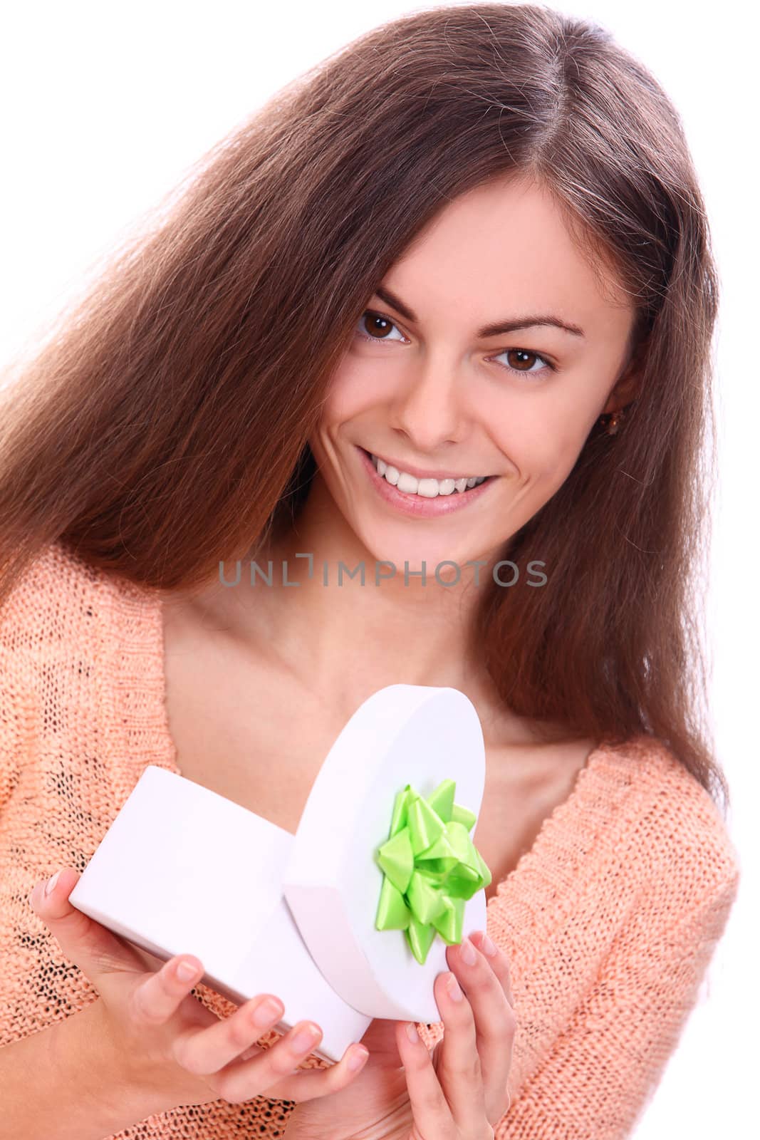 Cute and attractive woman in sweater opening a gift
