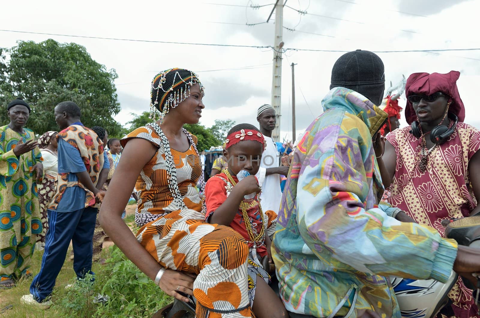 Kartiak,Senegal-September 18,2012 :family in motorbike,go to the ritual of Boukoutt of Initiation ceremony on Sept 18,2012 in Kartiak,Senegal.The ceremony occurs every 30 years and celebrates boys becoming men