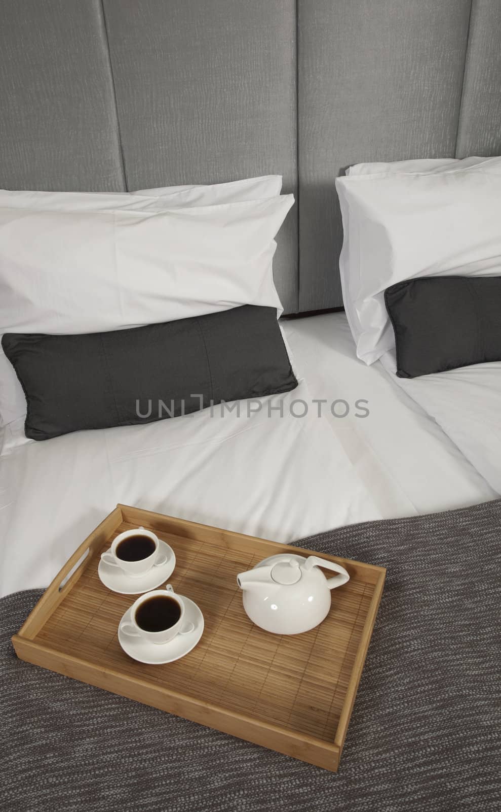 Tray with coffee on a bed in a hotel room