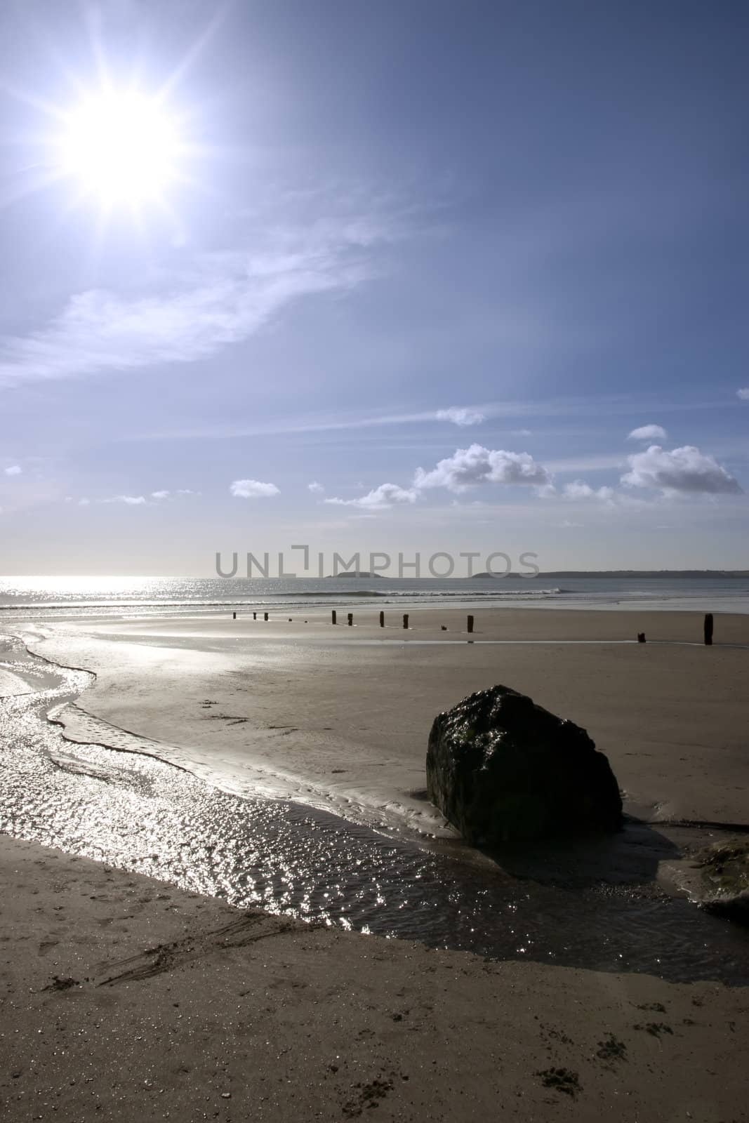 sunshine over the beach breakers in Youghal county Cork Ireland on a summers day